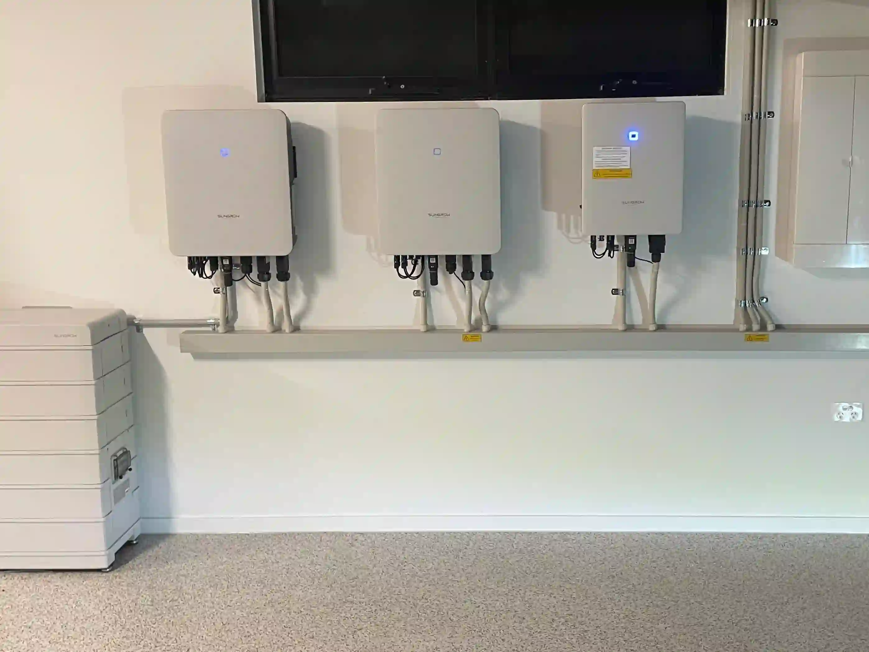 Solar battery storage system installed beside a wall